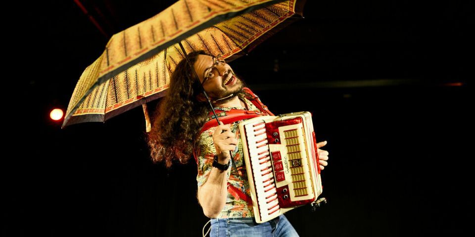 man with accordion and umbrella